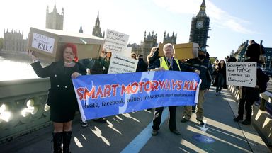 Smart motorways protester march across Westminster Bridge.